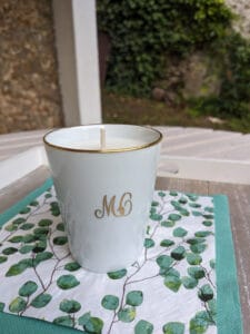 une bougie dans une tasse blanche sur une serviette